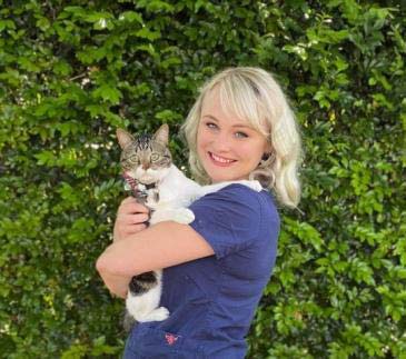Dr Jaimie Olsen, a veterinarian, poses with a cat